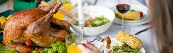 Partial view of girl near traditional thanksgiving turkey with fresh lettuce, banner — Stock Photo