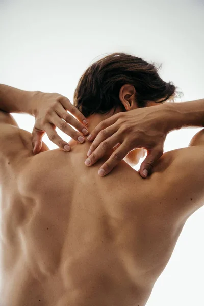 Back view of shirtless man with muscular body posing isolated on white — Stock Photo