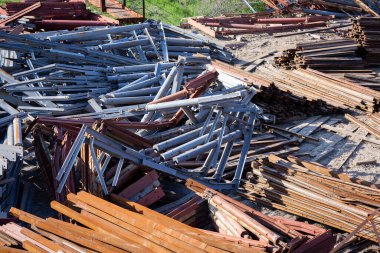 Açık bir alanda çelik bina yapıları depolanmış.