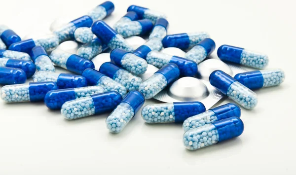 Medical blue pills with packaging — Stock Photo, Image