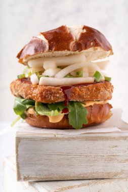 Etsiz nohut burgeri, şalgam cipsi, baharatlı mayonez, rochet ve biber soslu Asya füzyon vegan yumuşak ekmeği.