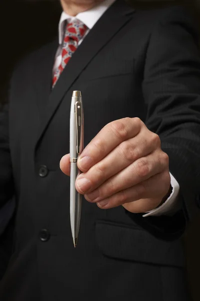 Businessman holding pen — Stock Photo, Image