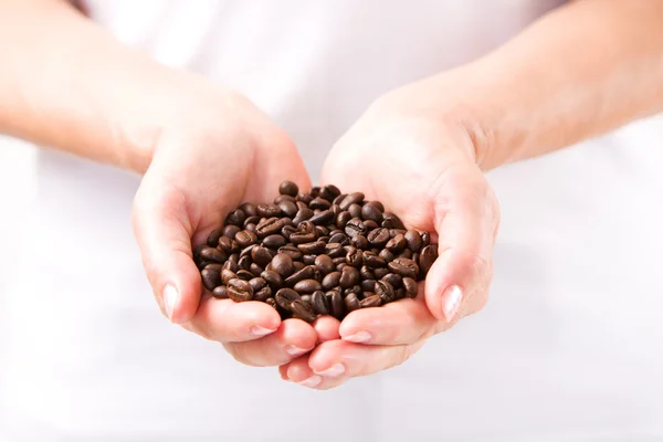 Coffee beans in female hands — Stock Photo, Image