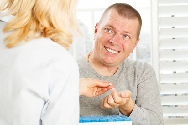 Hand gives a patient man the medicine — Stock Photo, Image