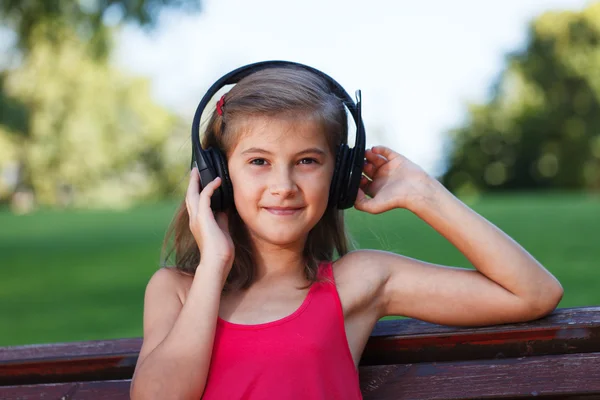 Relaxed Teenager girl listening music in park