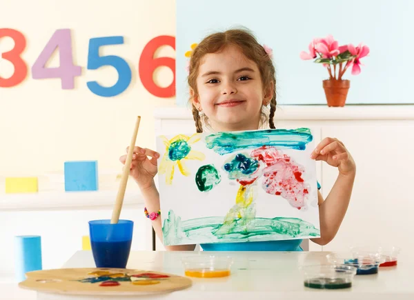 Little girl shows her painting — Stock Photo, Image