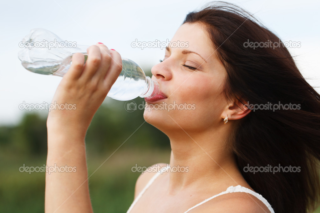Beautiful woman drinking water