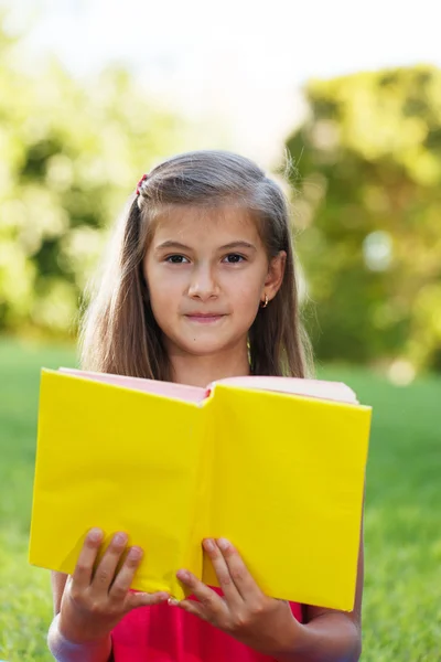 Little genius  with yellow book — Stock Photo, Image