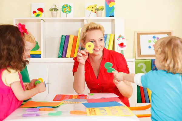 Pre-school children in the classroom with their teacher — Stock Photo, Image