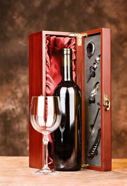 Vintage wine with glasses and case