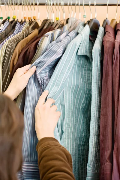 Hands on shirts in the store — Stock Photo, Image