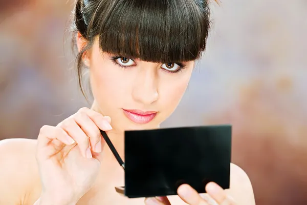 Mujer aplicando maquillaje — Foto de Stock