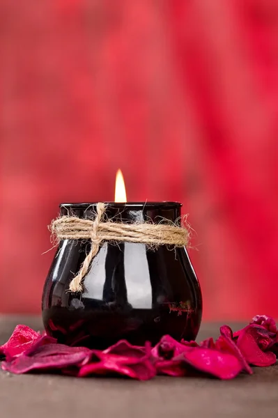 Black candle cup on red background — Stock Photo, Image