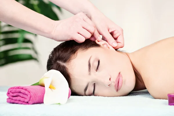 Woman on ear massage in salon — Stock Photo, Image