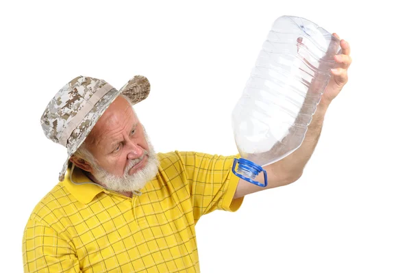 Senior man looking into empty bottle — Stock Photo, Image