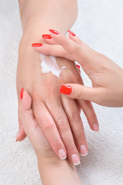 Beauty salon, hands massage with moisturizing cream — Stock Photo, Image