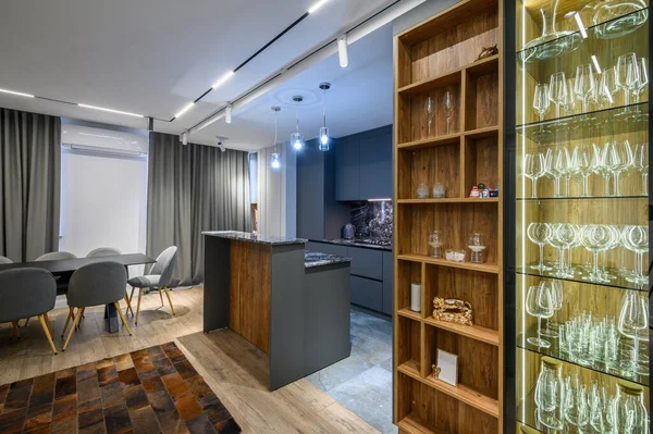 Luxury living room with large sideboard and grey kitchen in studio apartment interior