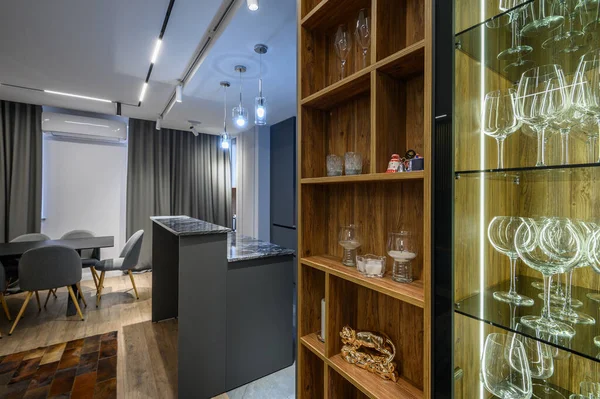 Luxury living room with large sideboard and grey kitchen in studio apartment interior