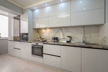 Interior of well designed modern trendy white kitchen