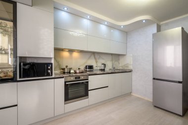 Interior of well designed modern trendy white kitchen