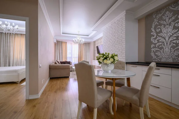 Luxury white and pink modern studio apartment interior with dining area, living area and bedroom