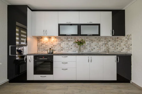 Interior renovation showcase of well designed modern trendy white kitchen, front view