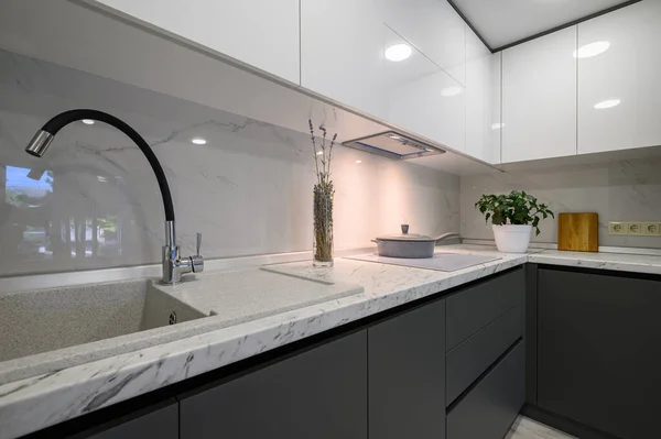 Closeup details of showcase interior of modern simple trendy dark grey and white kitchen