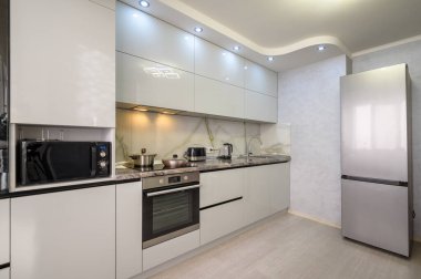 Interior of well designed modern trendy white kitchen