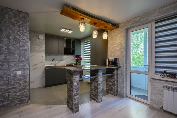 Real showcase interior of cozy designed modern trendy gray kitchen