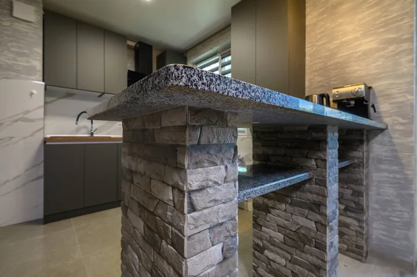 kitchen counter closeup at cozy modern trendy gray kitchen