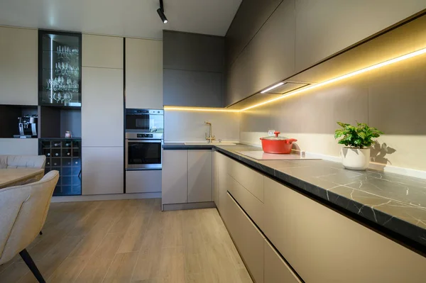 Modern grey luxurious kitchen furniture, closeup to expensive stone worktop