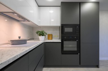 Showcase interior of modern simple trendy dark grey and white kitchen