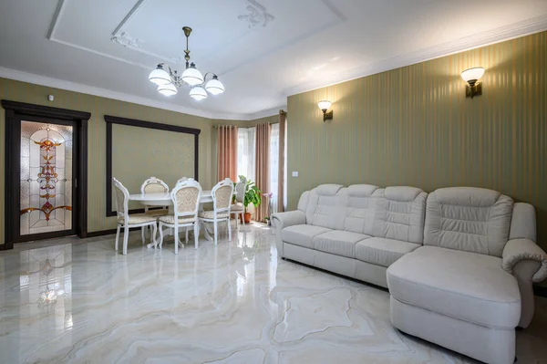 Classic living room interior design. Spacious room, luxury marble floor, table with elegant chairs and sofa