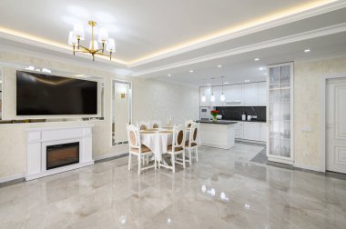 Luxury white large domestic kitchen with glossy marble floor, kitchen island and dining table