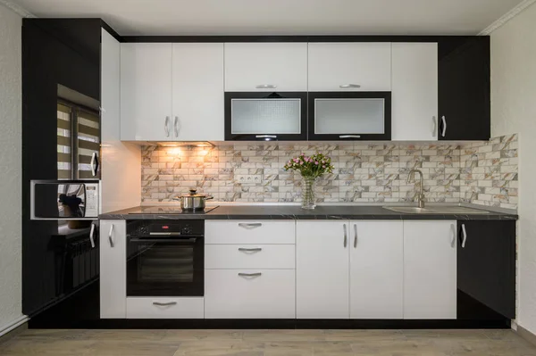 Interior renovation showcase of well designed modern trendy white kitchen, front view