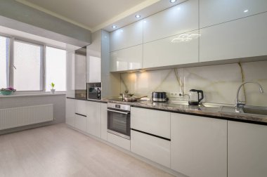 Interior of well designed modern trendy white kitchen