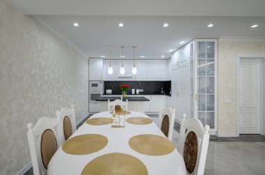 Luxurious large modern domestic kitchen with marble floor and serverd dining table