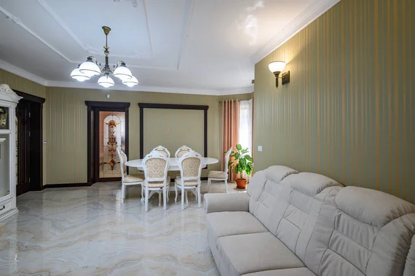 Classic living room interior design. Spacious room, luxury marble floor, elegant chairs and even fireplace