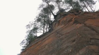Erglu Kayalıkları ve Gauja Nehri Cesis, Letonya Büyük Manzarası. Gauja Ulusal Parkı 'ndaki Sonbahar Manzarası Kızıl Kayalar Taş Kayalıkları ve Nehir. Stedicam Dolly 4K 'yı vurdu.