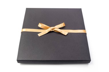 Siyah Cuma hediye paketi beyaz arka planda izole edilmiş altın kurdele yayı ile sarılı, kopyalama alanı, kırpma yaması dahil