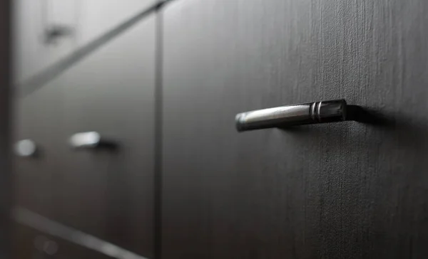 Drawer Cabinets with metal handles - extremely narrow selective and soft focus. Focus is on one of the metal handles