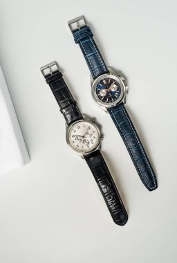 Studio shot of a two fancy luxury unbranded Men watches on white background. Stainless steel man's wrist watches with leather straps.