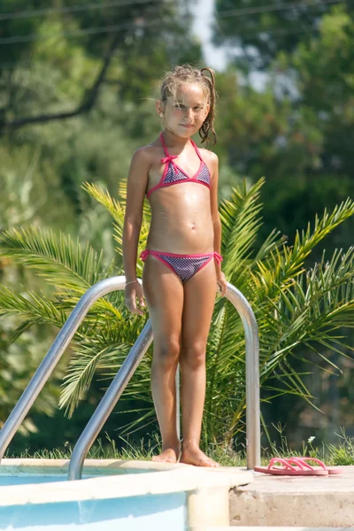 Girl by the swimming pool Stock Photo