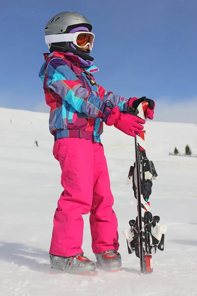 Flicka med skidor på snö — Stockfoto