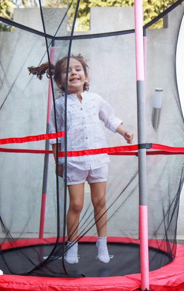 Girl in the trampoline — Stock Photo, Image