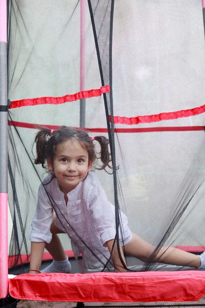 Girl in the trampoline — Stock Photo, Image