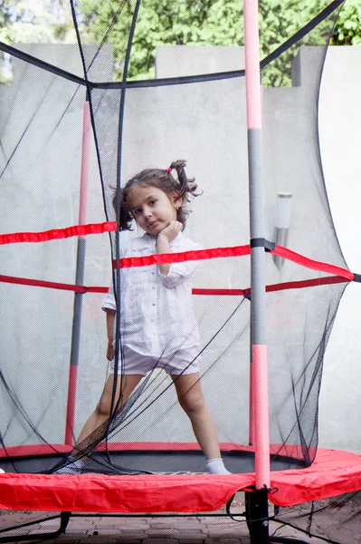 Girl in the trampoline — Stock Photo, Image