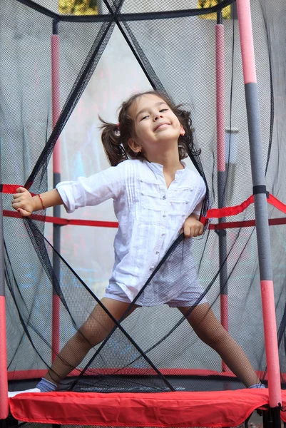 Girl in the trampoline — Stock Photo, Image