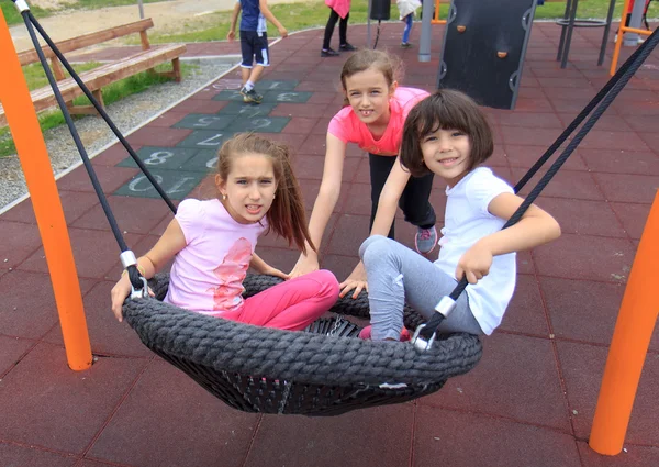 Girls on the swing — Stock Photo, Image