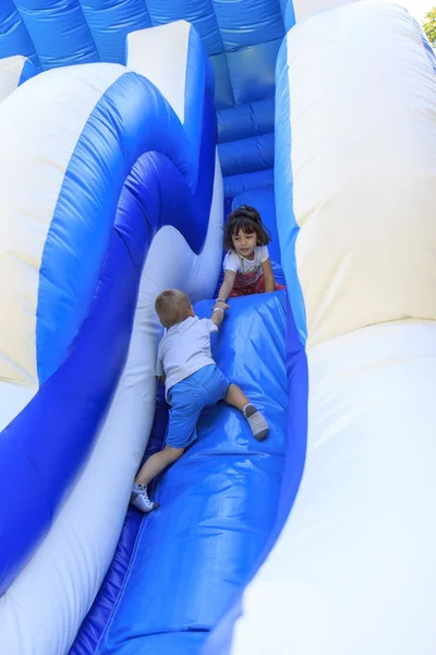 Girl on the trampoline slide — Stock Photo, Image